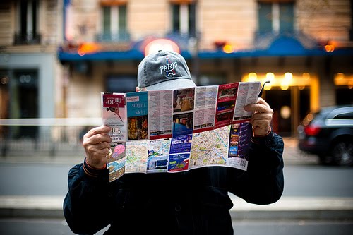 american tourist in paris with map